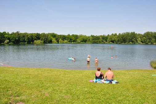 Badegäste liegen am Teich