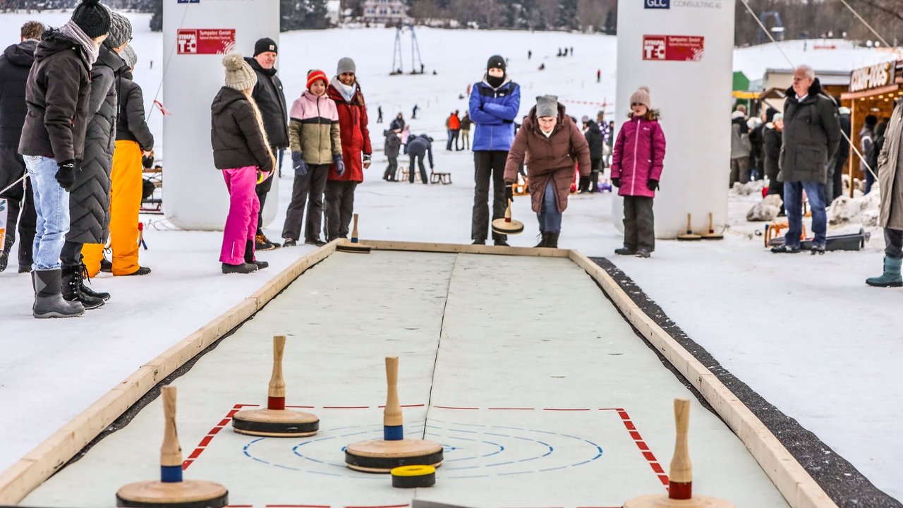 Familien spielen Eisstock schießen 